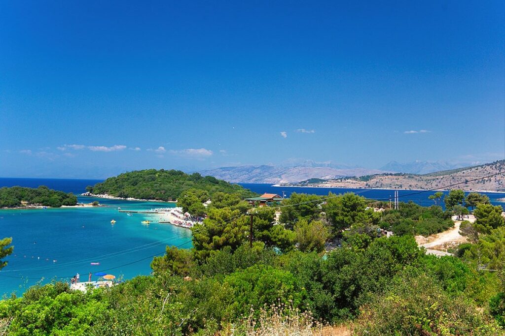 Albanian Riviera with turquoise waters, sandy beach, and green hills