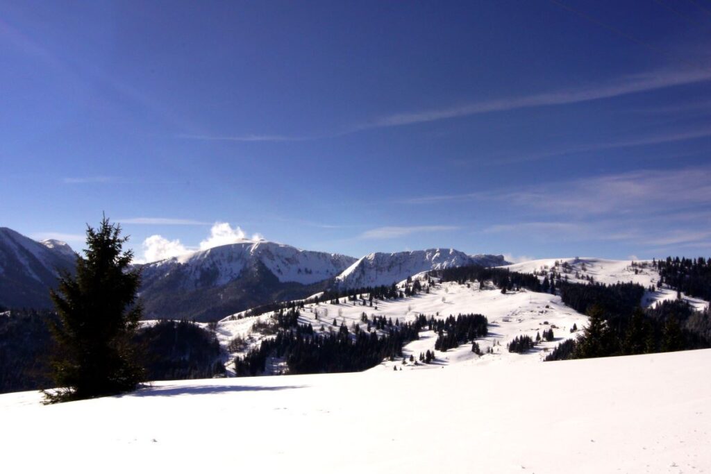 Snow-covered mountains under a clear blue sky in northern Albania boge