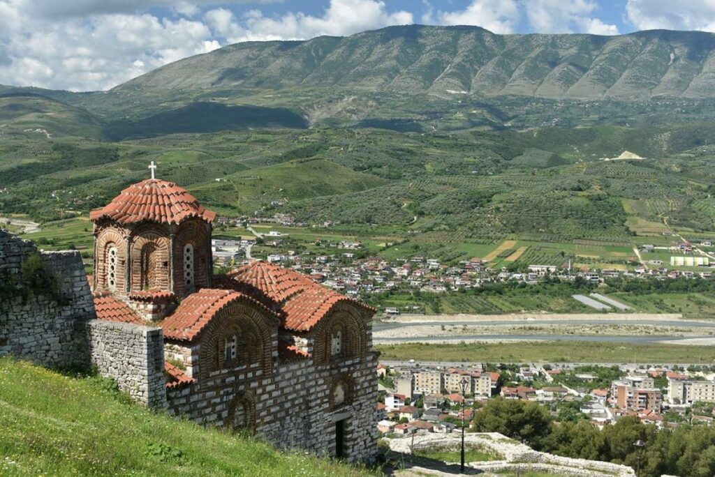 Berat Castle perched on a hill, overlooking the Osum River and the city below.