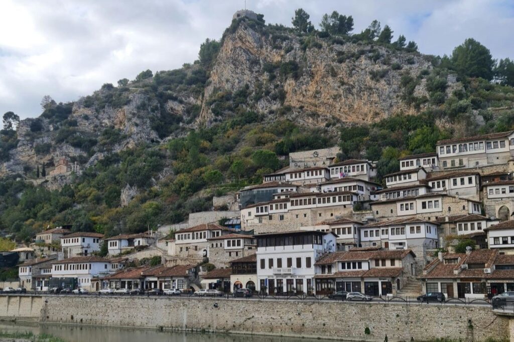 Berat’s iconic Ottoman-style houses reflected in the Osum River, a UNESCO World Heritage Site in Central Albania.