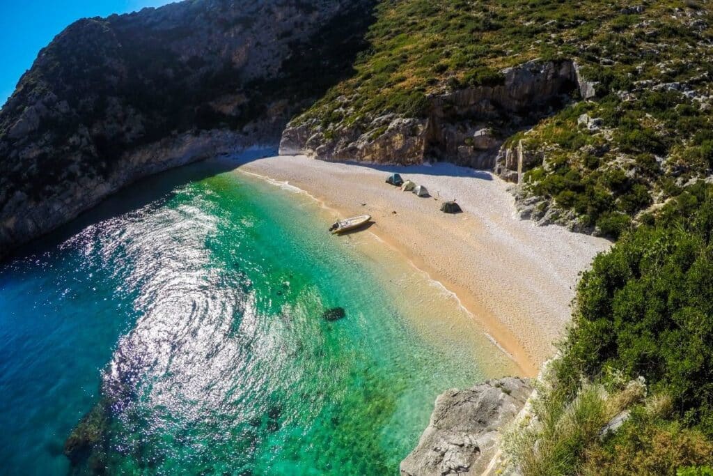 The secluded Grama Bay with its turquoise waters and dramatic cliffs, a hidden gem in South Albania.