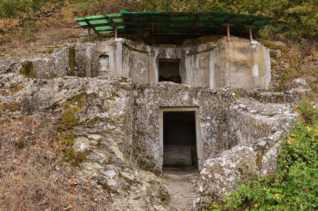 The ancient Illyrian tombs of Selca e Poshtme carved into rocky terrain, a mysterious Albanian landmark.