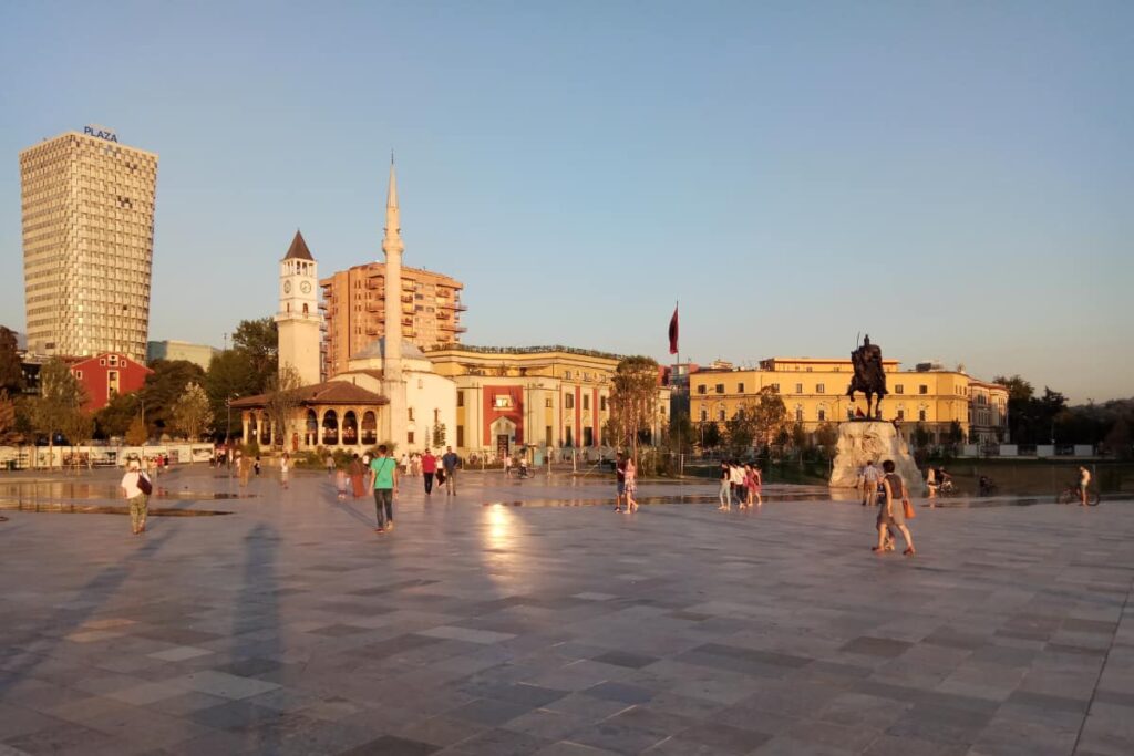 Why visit Tirana: Skanderbeg Square with its iconic landmarks and vibrant atmosphere.