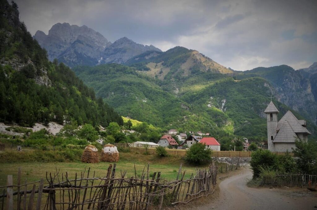 Hikers exploring the scenic Theth to Valbona trail in the Albanian Alps.