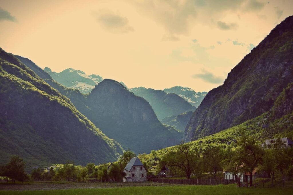 Theth National Park in Albania, featuring dramatic mountain peaks and lush greenery.