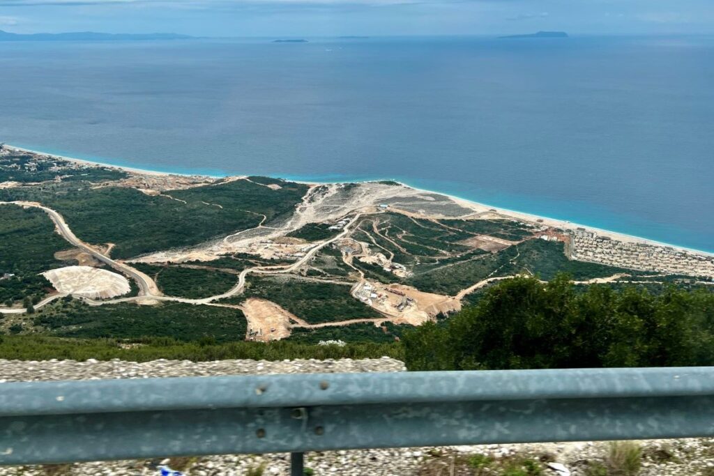 A car driving along the Llogara Pass, offering panoramic views of Albania’s stunning coastline.