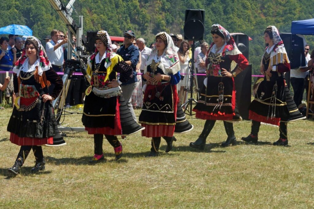 Women wearing traditional xhubleta skirts during a festival in Northern Albania.