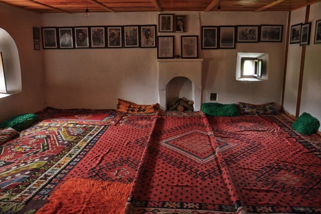 An artisan weaving a colorful rug in a traditional workshop in Shkodër, Northern Albania.