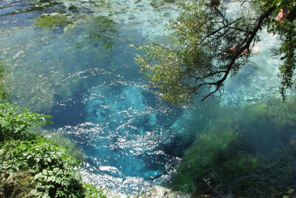 The Blue Eye spring in Albania, with vivid turquoise waters and lush green surroundings.