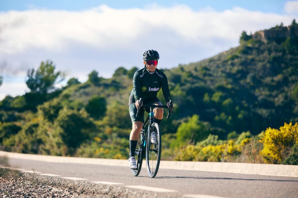 A cyclist exploring the stunning coastal paths near Ksamil, showcasing eco-friendly travel in Albania.