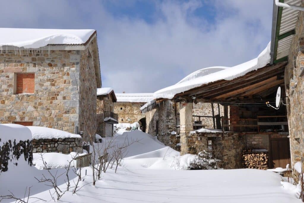 The snow-covered village of Dardha in Albania, surrounded by wintery landscapes.