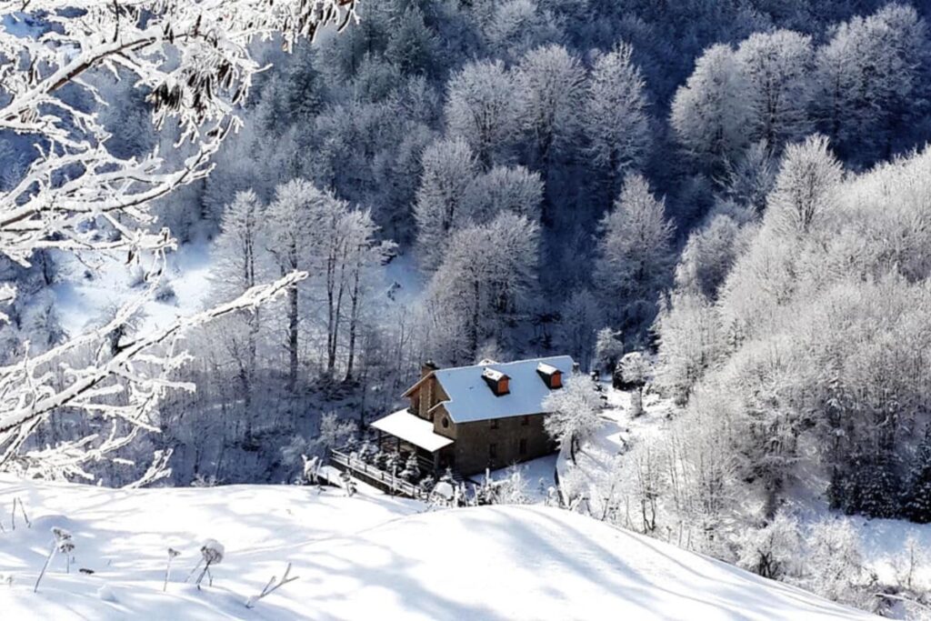 Winter in Albania: A snow-covered village with cozy guesthouses in Dardha.