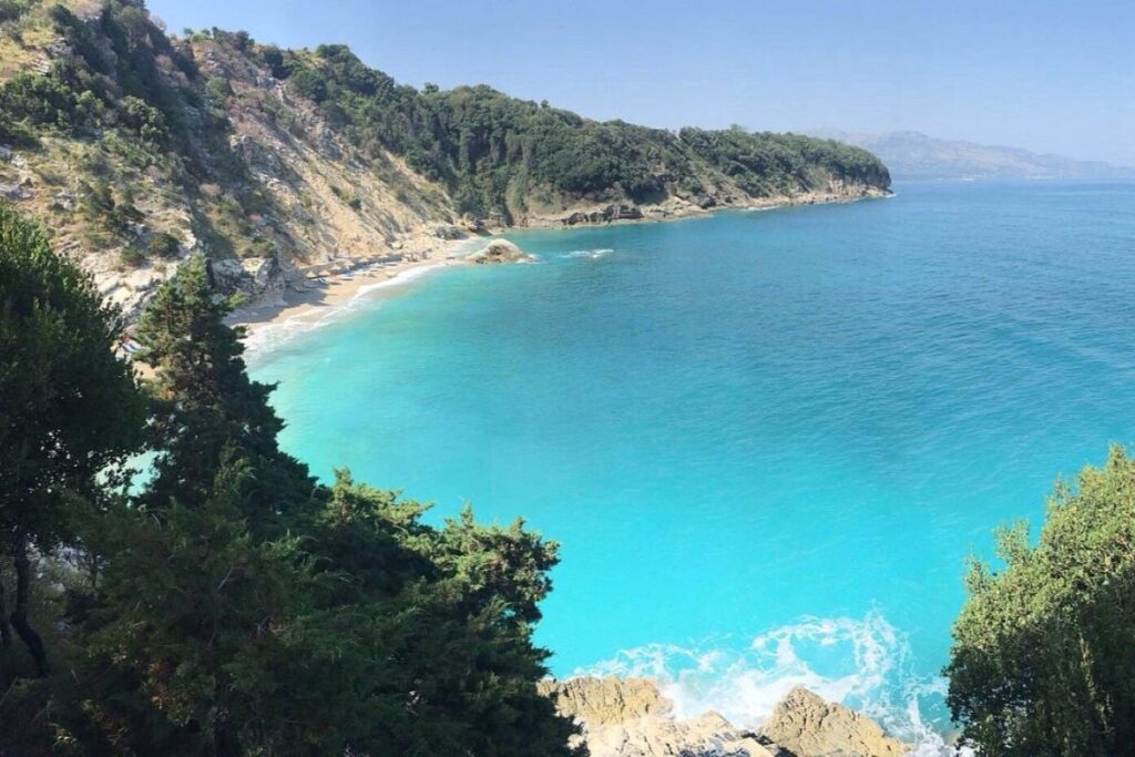 Pulebardha Beach in Saranda, featuring clear turquoise waters and surrounding cliffs, a hidden gem in South Albania.