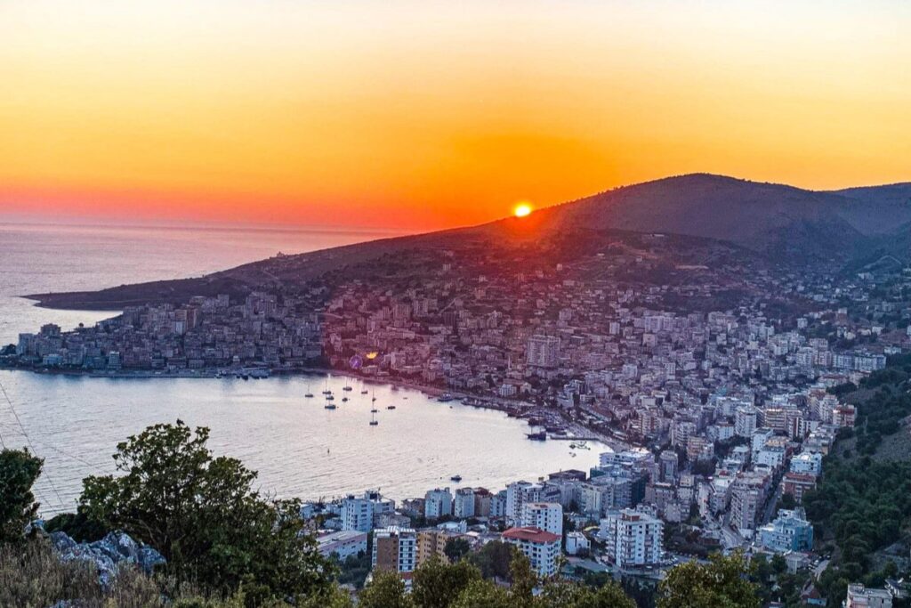 A stunning sunset view of Saranda’s coastline with the Ionian Sea and city lights.