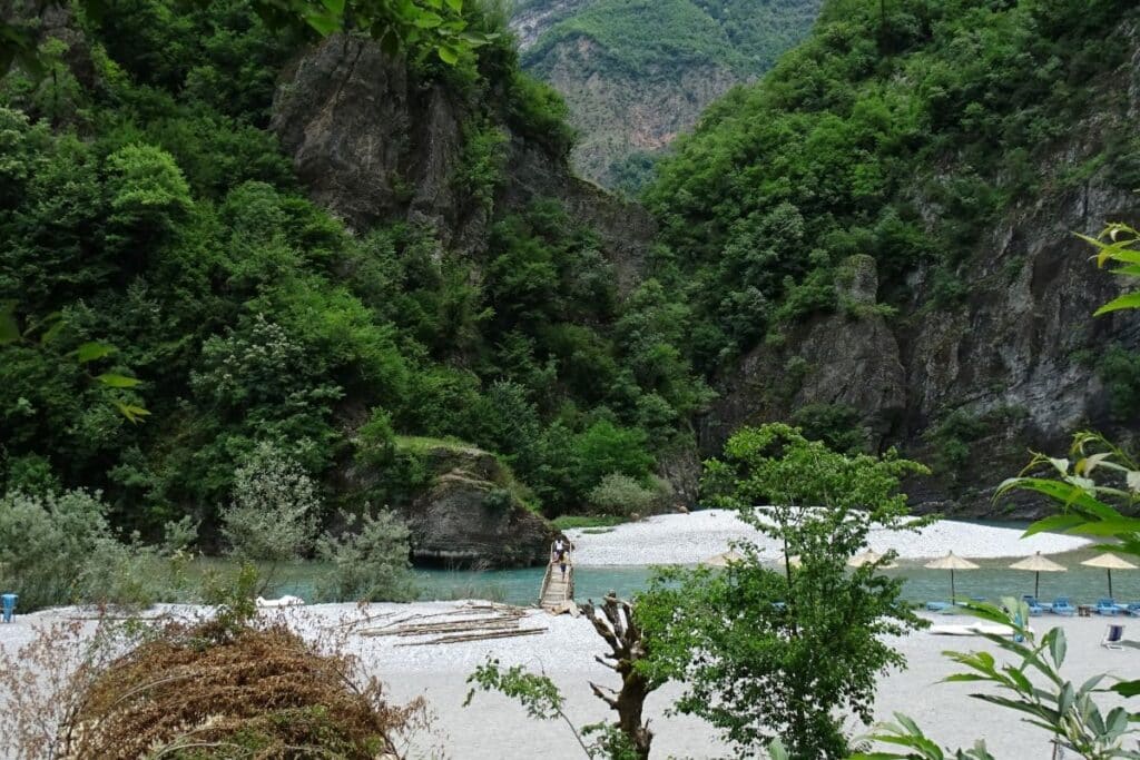 TThe pristine Shala River winding through dramatic cliffs and lush greenery in North Albania