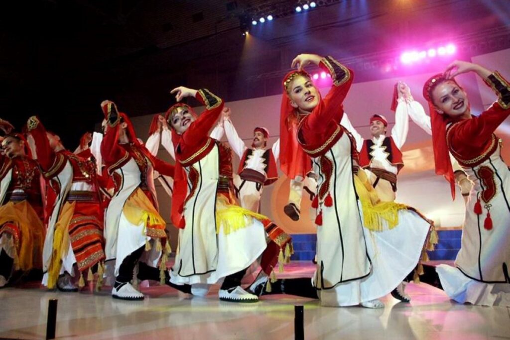 Albanian dancers performing in traditional costumes on stage