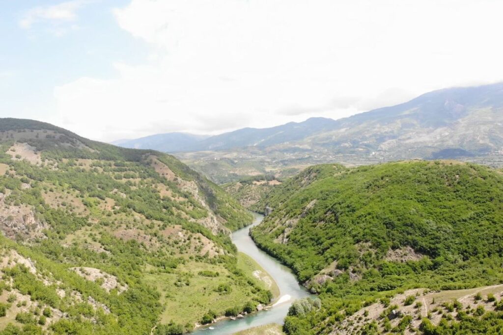 The Black Drin River flowing through Dibra’s picturesque valley with the Korab Mountains in the background.