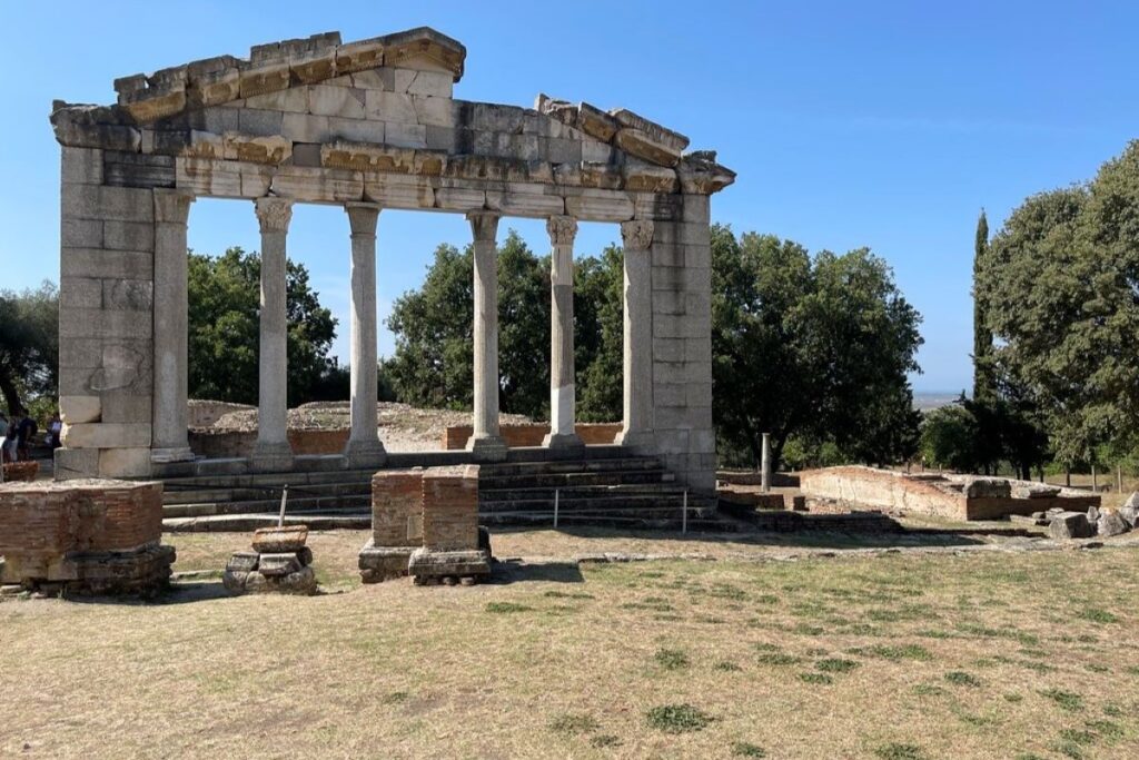 Ruins of a Roman temple in Apollonia with four columns and a broken pediment.