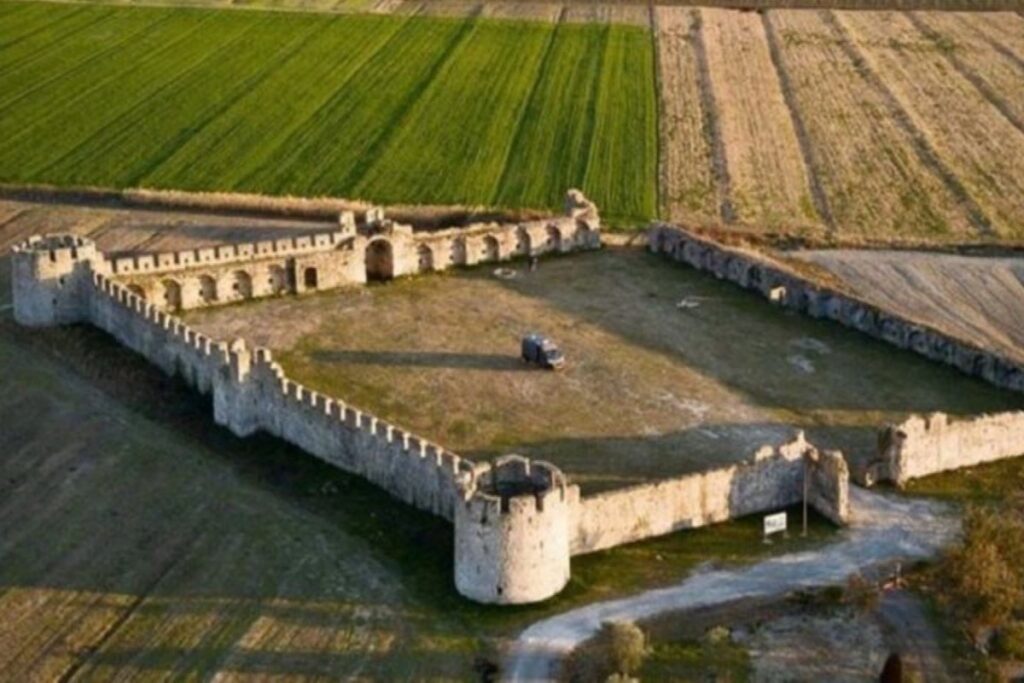 Aerial view of Bashtova Fortress surrounded by fields in Albania